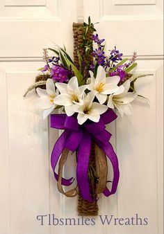 a door hanger with purple and white flowers