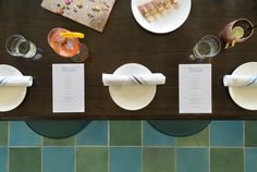 the table is set with plates, glasses and utensils