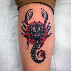 a tattoo on the leg of a person with a scorpion and heart in the background