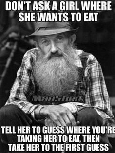 an old man with a long beard wearing a hat and plaid shirt is sitting down