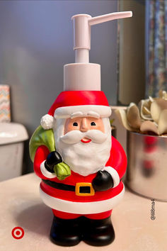 a santa clause soap dispenser sitting on top of a counter