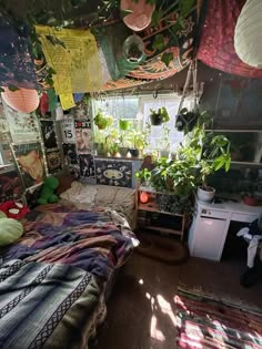 a bedroom with lots of plants hanging from the ceiling