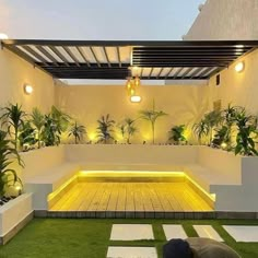 an outdoor living area with grass and lights