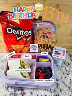 the lunch box is filled with healthy food and has happy birthday messages on it for everyone