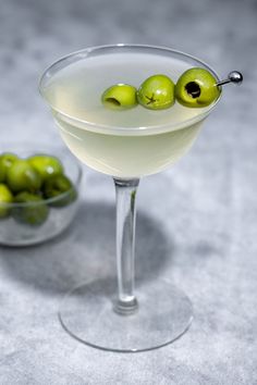 a martini glass with olives in it