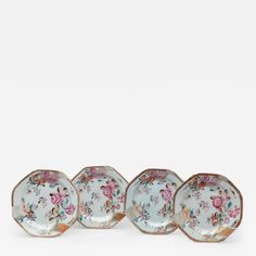 four small plates with floral designs on them