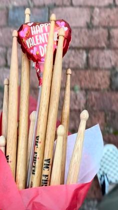 a bunch of wooden baseball bats in a bouquet with a happy valentine's day sign