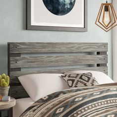 a bed with a wooden headboard and pillows