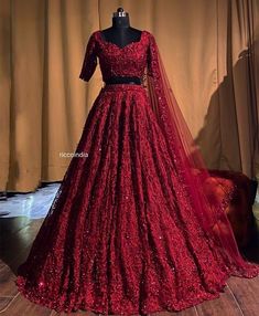 a red dress on display in front of a curtain