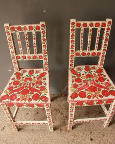 two painted wooden chairs sitting next to each other