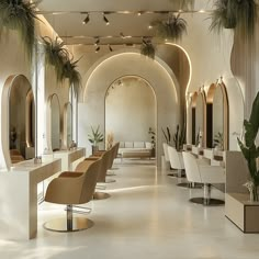 the interior of a hair salon with chairs, mirrors and potted palm trees on the wall