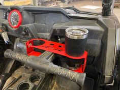 the inside of a vehicle that is being worked on by a man with a wrench