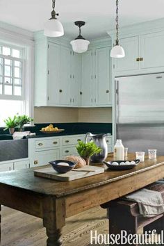 a kitchen with white cabinets and an island