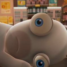 an animated character with big blue eyes laying on the ground in front of a store