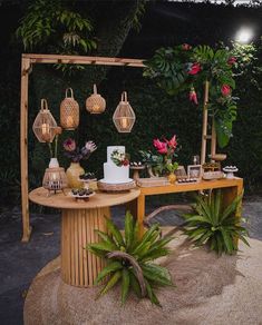 a wooden table topped with a cake covered in flowers