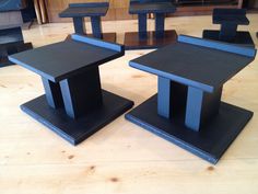 two black tables sitting on top of wooden floors