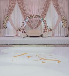 a wedding stage decorated with pink and white flowers