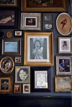 there are many framed pictures on the wall