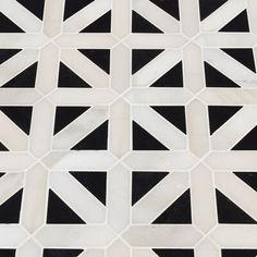 a black and white tiled floor with geometric designs