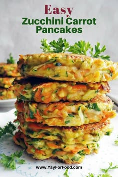 zucchini carrot pancakes stacked on top of each other with parsley in the background