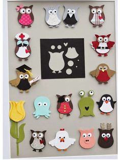 an art project with paper cut outs and owls on the front, in white frame