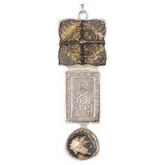 A three-tired drop pendant of mixed ancient artifacts and coin set in sterling silver, with a hand-made Native American Indian sterling silver chain. This artisan-crafted piece is comprised of a Roman era artifact at top, with 1 Bu (Ichibu) Japanese Shogun period, silver (circa 1837-1868), and an ancient Greek, Macedon, Phillip II, Bronze coin (circa 359-336 BC) with Apollo and horse and rider on reverse. The components of this pendant have been inspected and approved to be authentic by a professional Numismatic who specializes in ancient coinage. A Certificate of Authenticity will accompany this piece. Pendant (with bail) measures approximately 3 1/4" tall, 7/8" in diameter, and 3/8"deep at bail. Then Native American Indian chain is 24" in length and is included with pendant. Japanese Shogun, Roman Era, Coin Set, Ancient Artifacts, Coin Necklace, Horse Rider, Macedonia, Native American Indians, American Indian