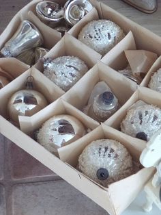 a box filled with christmas ornaments on top of a table