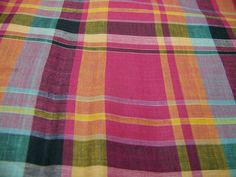 the fabric is very colorful and has many different plaid patterns on it's surface