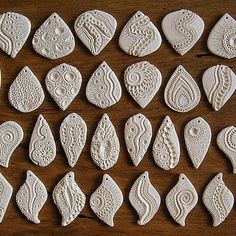 white ceramic ornaments are arranged on a wooden surface