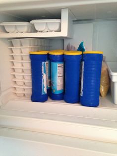 there are three plastic containers in the refrigerator