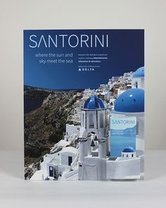 the front cover of a magazine with blue domes and white buildings on it's sides