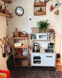 a kitchen area with various items on the shelves