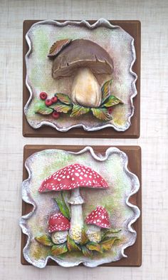 two ceramic plaques with mushrooms and leaves on them