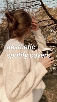 a woman in a white sweater holding a coffee cup with the words aesthetic spotify covers