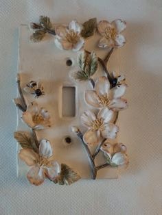 a light switch cover with flowers on it