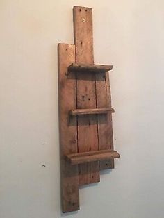 a wooden shelf mounted to the side of a wall