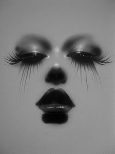 a woman's face with black and white makeup