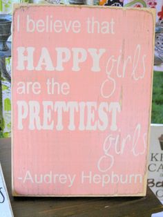 a wooden sign that says, i believe that happy girls are the prettiest girl