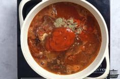 a white bowl filled with soup on top of a table