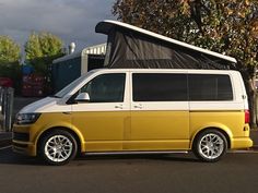 a yellow van is parked in the parking lot