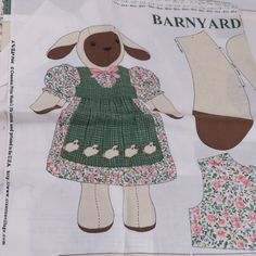 the paper doll is made to look like a sheep wearing a green dress with flowers on it