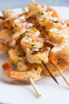 grilled shrimp skewers on a white plate