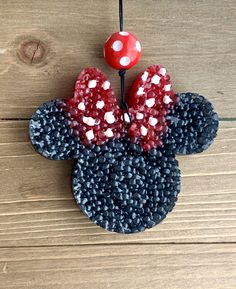 a close up of a mickey mouse decoration on a wooden surface