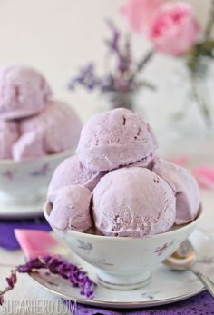 a bowl filled with purple ice cream on top of a table