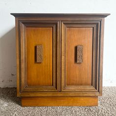 an old wooden cabinet with two doors on it