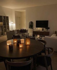 candles are lit on a table in the living room