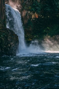 a large waterfall is coming out of the water