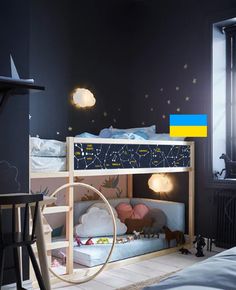 there is a bunk bed in the room with stars on the wall and other decorations