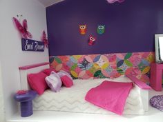 a bedroom with purple walls and white bedding, pink pillows and colorful wall decor