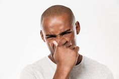 a man holding his nose with both hands